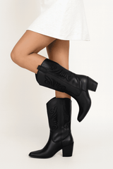 Black embroidered cowboy boots on model